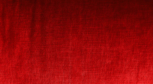 istock Red fabric texture background with subtle sheen. Elegant textile surface for design, fashion, upholstery, or abstract backdrop. High-quality natural fibers. 2230456567