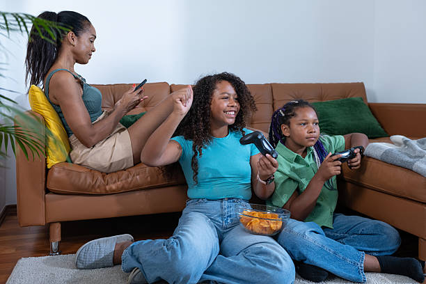 Children gamers playing video games on a console together as at home.
