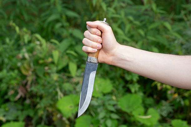 istock A man with a knife in his hands. Aggression and death threats. 2230461133