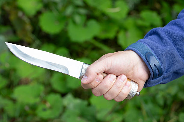 istock A man with a knife in his hands. Aggression and death threats. 2230461166