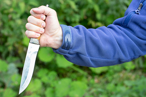 istock A man with a knife in his hands. Aggression and death threats. 2230461203