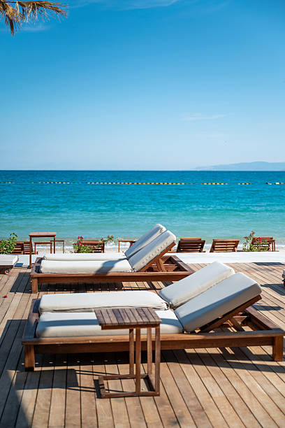 istock Empty Wooden Sunbeds with sea view on the beach 2230475989
