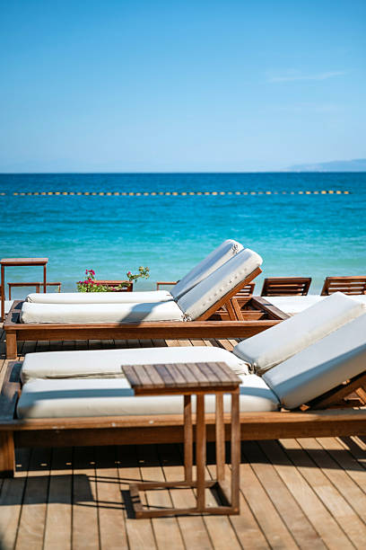 istock Empty Wooden Sunbeds with sea view on the beach 2230476011