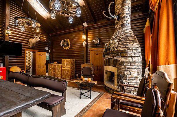istock A rustic cabin with a fireplace and a large head mounted on the wall 2230476949
