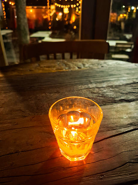 Candle on table softly illuminates the wooden area