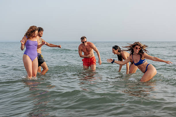 istock Friends enjoying a day at the beach 2230483803