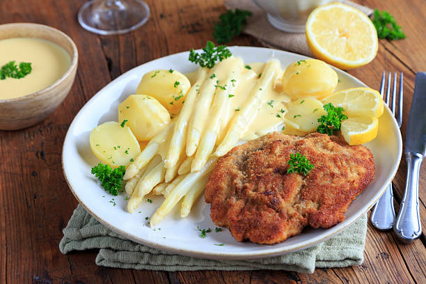 istock Asparagus with hollandaise sauce and Wiener schnitzel 2230487757