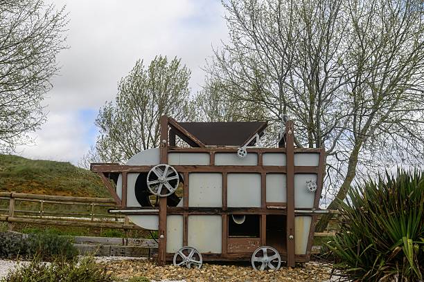 Historic grain winnowing machine with metal wheels on display in San Martin del Valle, Palencia.