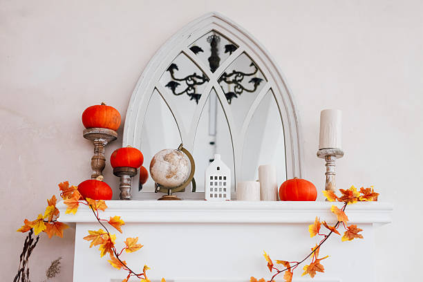 istock Decorative autumn mantel with pumpkins globe and leaves in cozy interior setting 2230488359