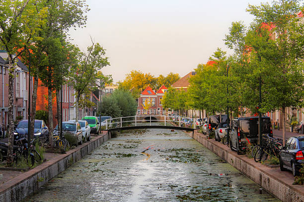 Delft, the Netherlands - August 2025: View on canal houses in the city centre of Delft. Delft is known for it's pottery, Delft Blue / Delftware (made at the Royal Delft), the Delft University of Technology (TU Delft), the famous painter Johannes (Jan) Vermeer and it's connections to the Dutch Royal family House of Orange-Nassau.