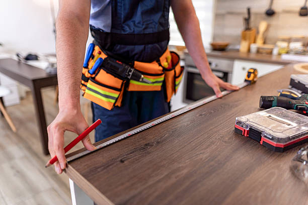 istock Skilled worker measures wooden surface with tool in modern kitchen during home improvement project 2230490320