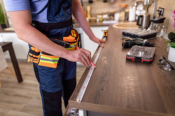 istock Carpenter measuring wooden countertop in modern kitchen during home renovation project 2230490336