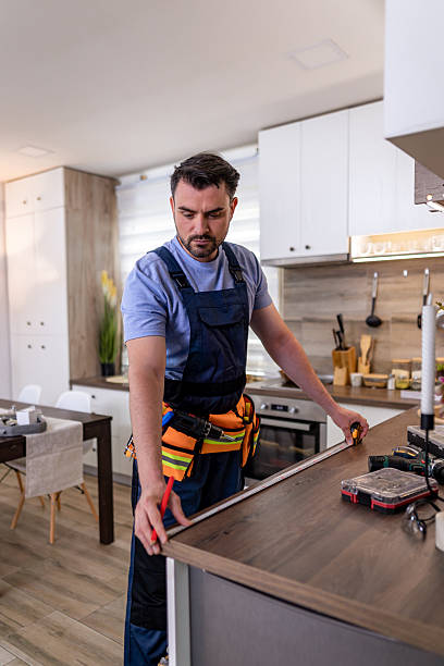 istock Skilled worker installing kitchen cabinetry in modern home during daylight hours 2230490429