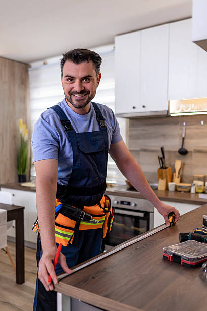 istock Skilled carpenter measuring kitchen countertop with tools in modern home during daytime 2230490439
