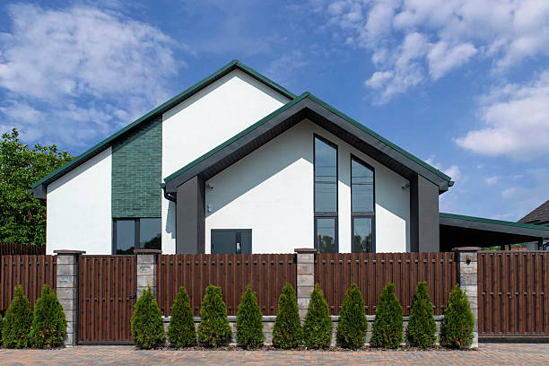 Modern house with brown metal picket fence