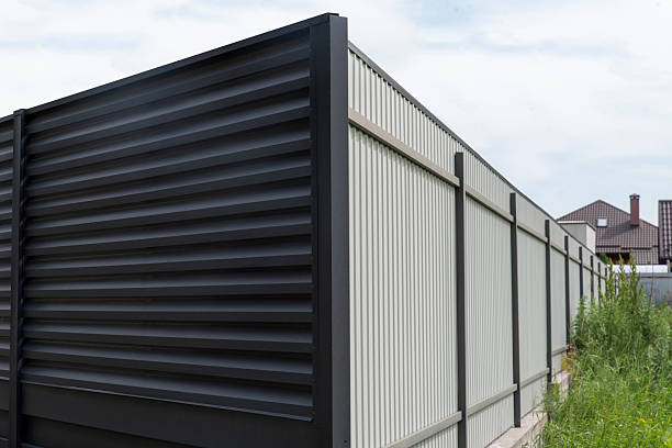 istock Modern metal fence with horizontal and vertical corrugated panels 2230495490