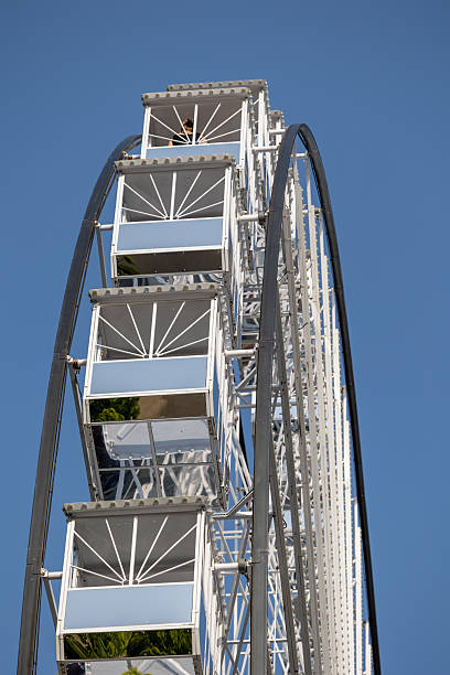istock Ferris wheel gondolas reflecting blue sky on a sunny day 2230496803