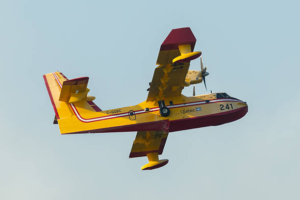 Halifax, NS, Canada - August 12, 2025 - A Canadair CL-415 SuperScooper operated by the Quebec government makes a water pickup while aiding to extinguish a wildfire near Susies Lake.