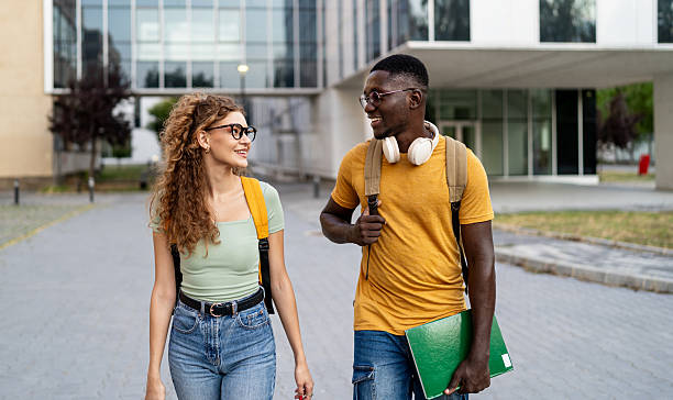 istock University students walking and talking outdoors 2230499593
