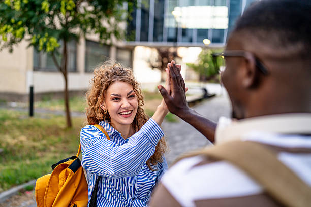 istock Happy students giving high five outdoors 2230499815