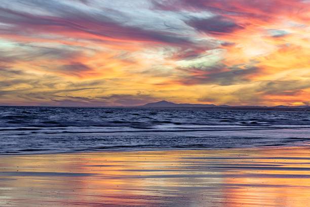 istock Vibrant sunset over ocean with colorful reflections. 2230499899