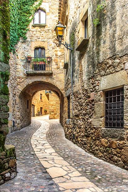 istock Charming medieval cobblestone alley with archway. 2230499987