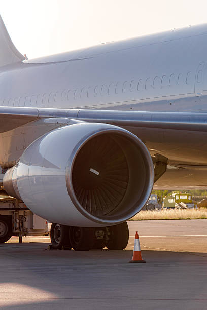 istock Jet engine close-up with servicing equipment on the airport runway at sunset 2230500145