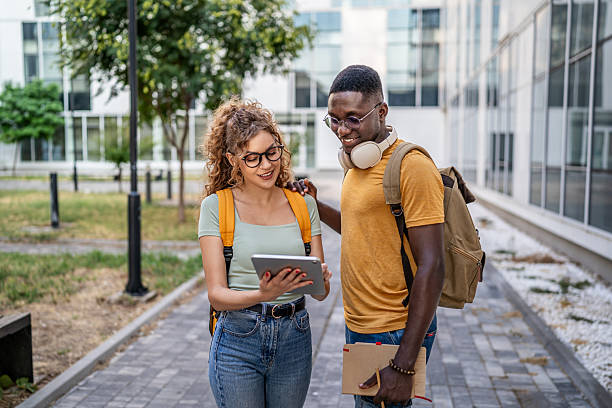 istock University students consulting digital tablet on campus 2230500691