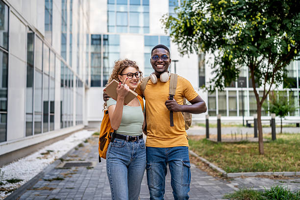 istock Cheerful multi-ethnic students walking together on campus 2230500787