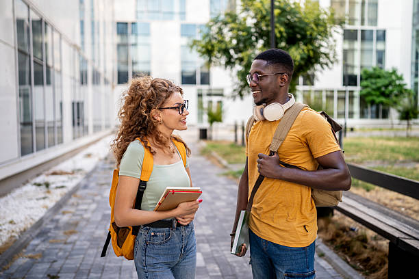 istock Smiling students talking outdoors 2230500945