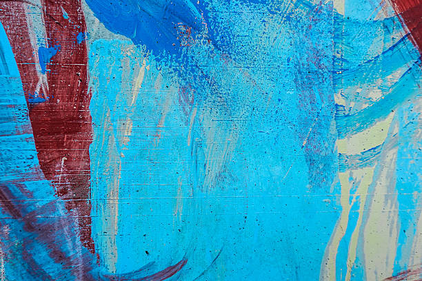 istock Messy multicolor brush strokes. Light blue, red, white, blue paint drips, flows, streaks on wall outdoors 2230501598