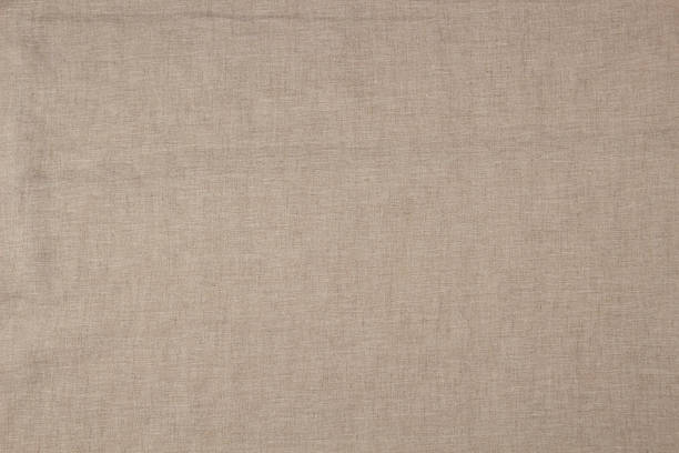 istock Textured linen background in soft beige color. Natural linen fabric material texture background. Top view 2230501701
