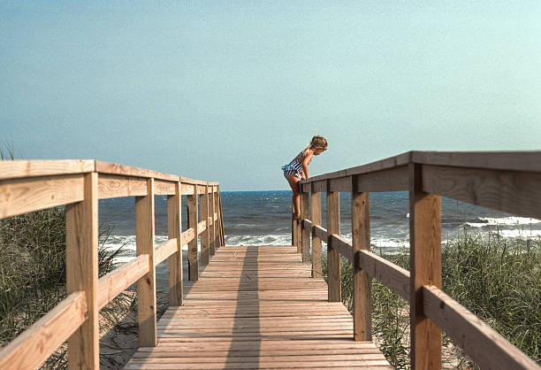 Cape Hatteras NS - Girl  Climbs on Boardwalk Railing - 1983. Scanned from Kodachrome 25 slide.