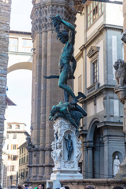 The statue of Perseus holding Medusa's head in Florence's Loggia dei Lanzi, showcasing Renaissance art and architecture.