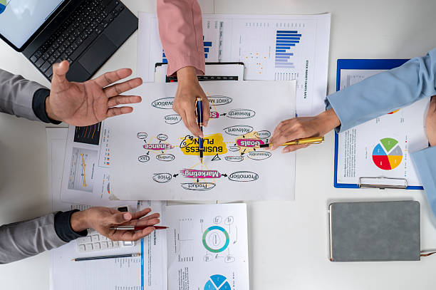 istock Business people working on a business plan using charts and mind maps 2230510292