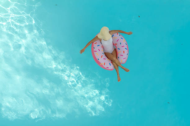 istock Girl in the pool with inflatable swim ring 2230510655