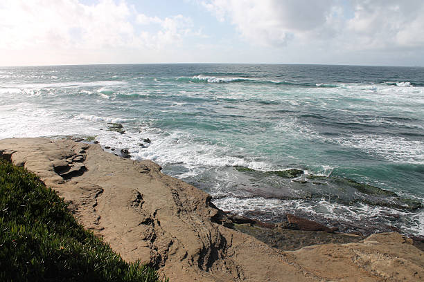Rocky cove fills the foreground leading back to the receding coastline of Point Loma's Sunset Cliff Park and ocean front homes, San diego, California