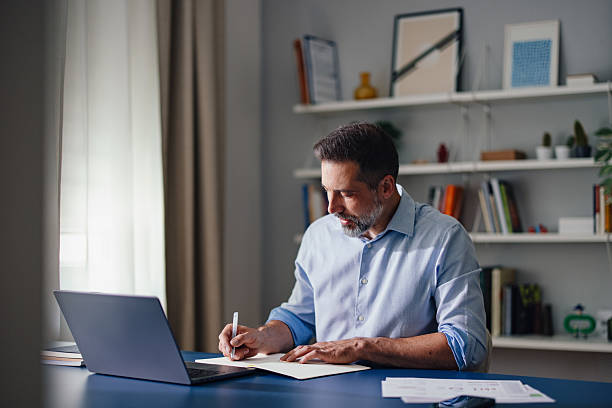 istock Professional Man Working in Home Office with Laptop and Documents 2230546998