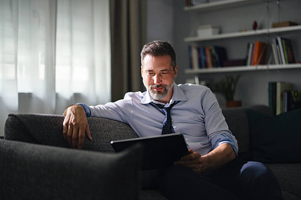 istock Businessman Working on Tablet in a Comfortable Home Setting 2230547051