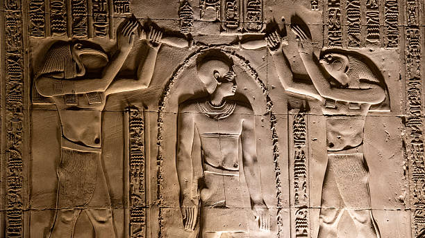 Kom Ombo, Egypt - Feb 8, 2025:  relief of Thoth and Horus purifying Pharaoh Ptolemy at Kom Ombo Temple, Aswan, Egypt.