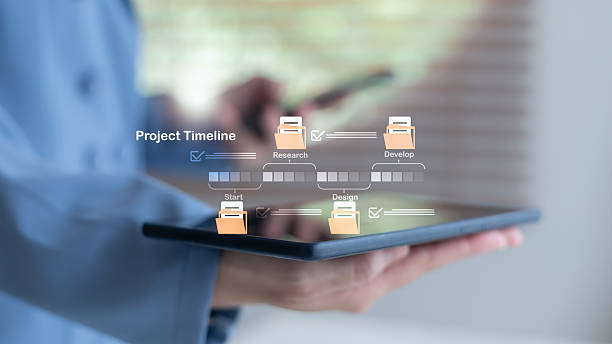 istock Businesswoman holding a digital tablet with a project timeline chart, project management process including research, design, and development stages. Technology in business planning and scheduling. 2230550220