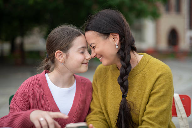 istock Tender moment between mom and and daughter, touching with foreheads. 2230551209