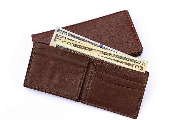 istock Worn Brown Leather Wallet with U.S. Dollar Bills and Card Compartments on White Background 2230551697