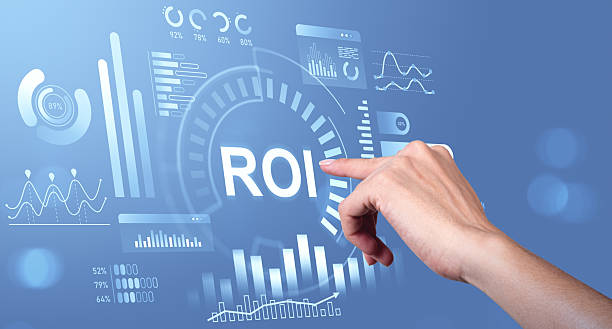 istock Hand pointing at ROI interface with digital charts and graphs on blue background representing business analytics and investment return concept. 2230552457