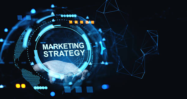 istock Futuristic digital interface showing a glowing Marketing Strategy concept in a human hand surrounded by tech elements and blue holographic visuals. 2230552837