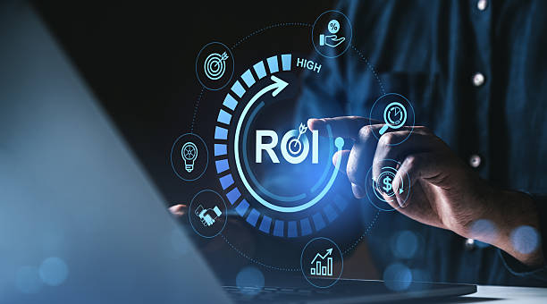 istock Businessman touching digital ROI interface with futuristic financial icons representing return on investment concept on dark background. 2230553364