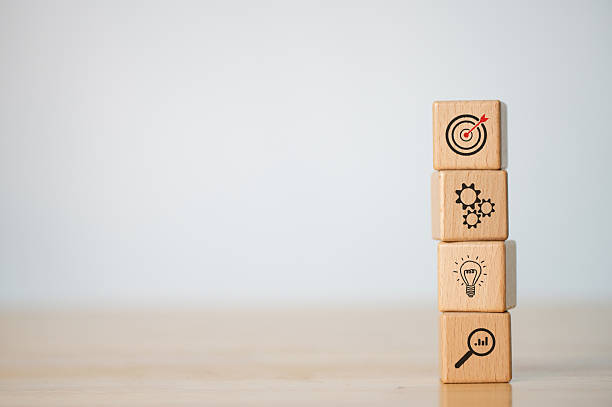 istock Wood cube block stacking with icon. business strategy and action plan Concept. 2230556856