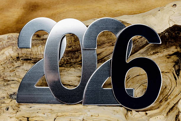 istock New Year 2026 with metallic numbers on wooden background 2230557672