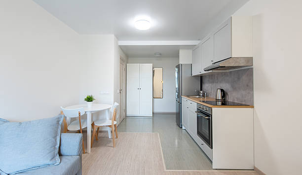 istock Modern Home Kitchen With White Cabinets and Appliances in Bright Surroundings 2230557942