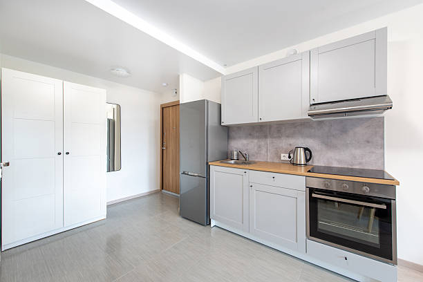 Modern Home Kitchen With White Cabinets and Appliances in Bright Surroundings